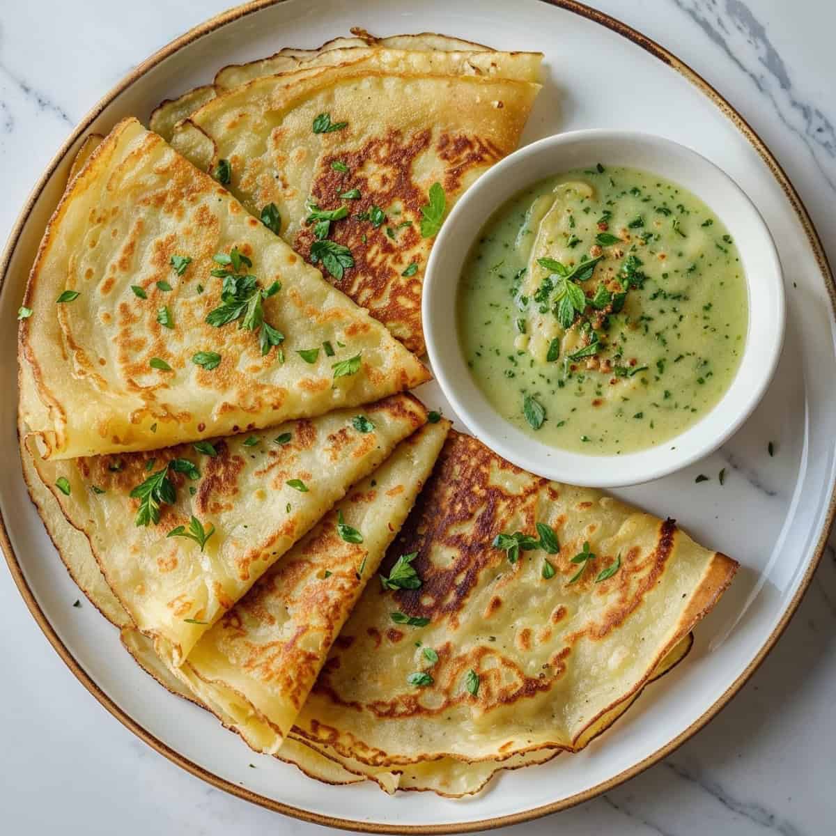 Plate of golden-brown Sherpa riki kur potato pancakes with creamy cheese sauce – traditional Nepali breakfast in Toronto